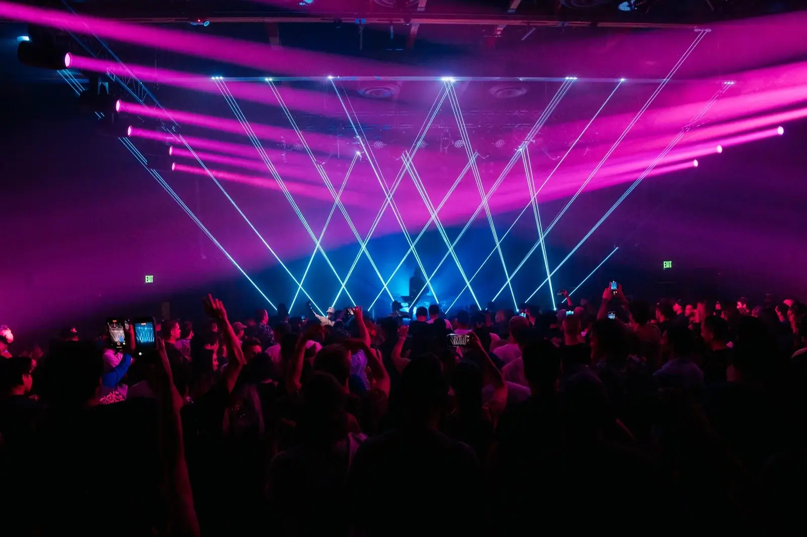 Vermont Hollywood nightclub crowd under laser show with pink and blue stage lighting